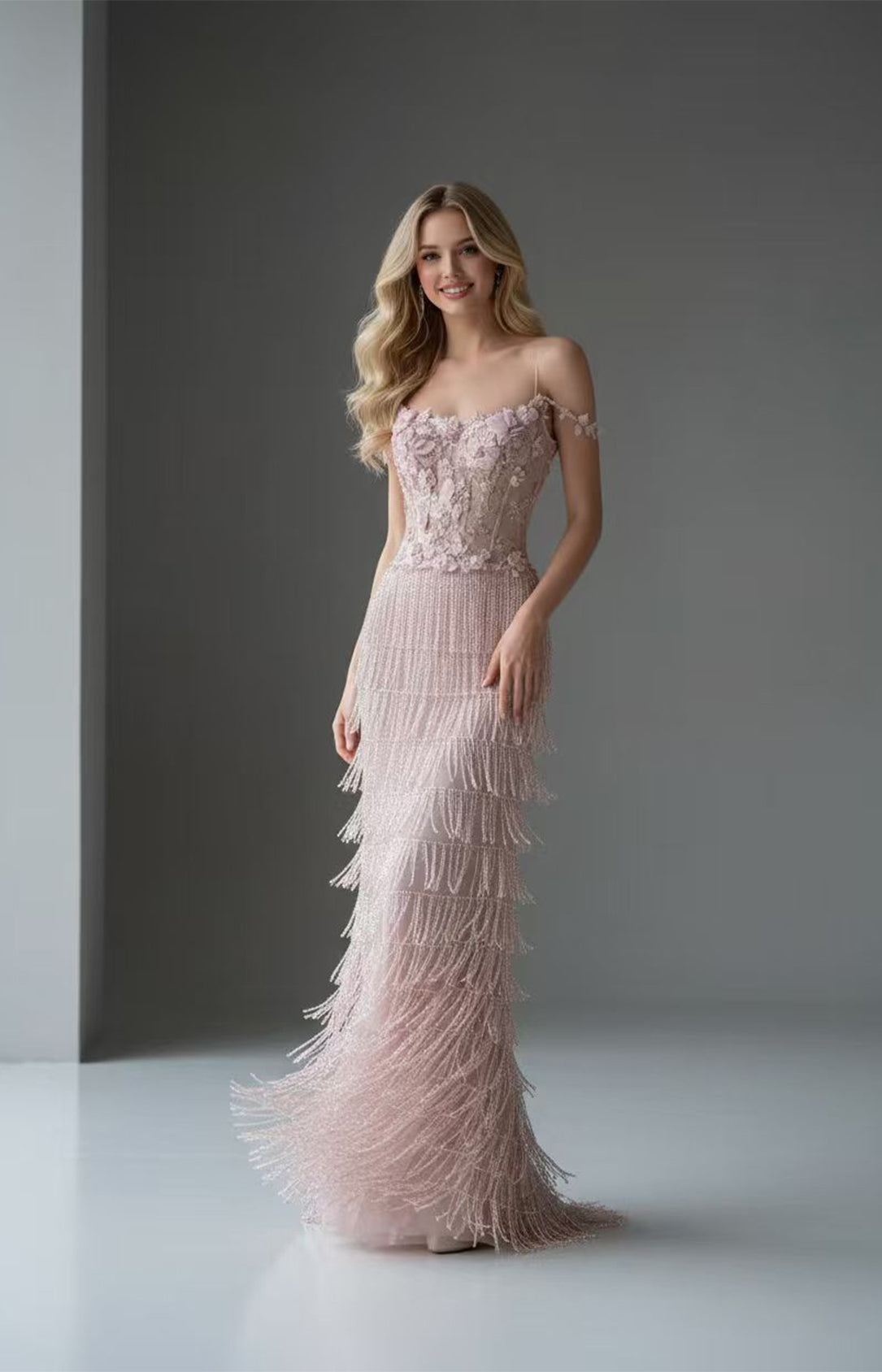 Front view of blush pink beaded fringe formal evening gown with floral applique by Xalpheor
