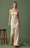 Champagne satin square-neck dress with fitted bodice and clean seam detailing, close-up

