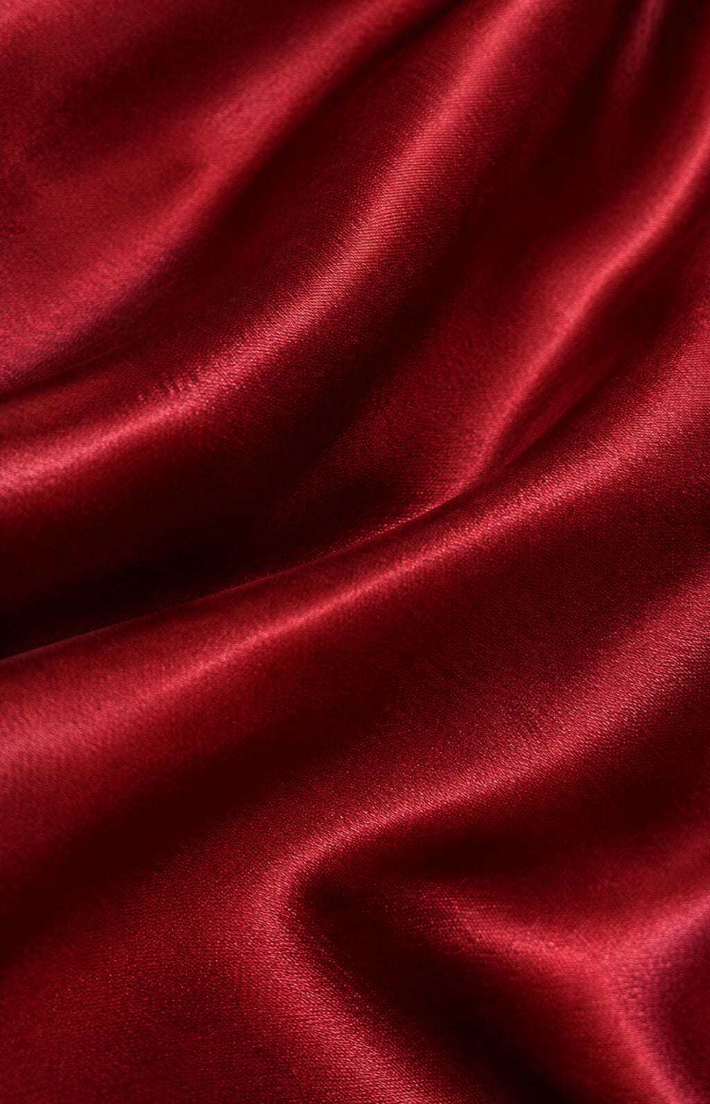 Close-up of burgundy satin fabric texture prom dress fabric