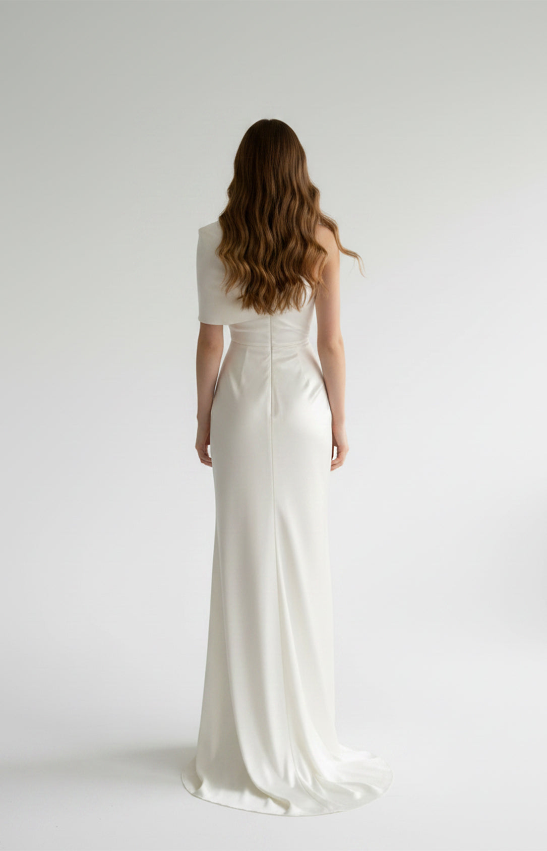Floor-length white satin evening gown with draped one-shoulder back view