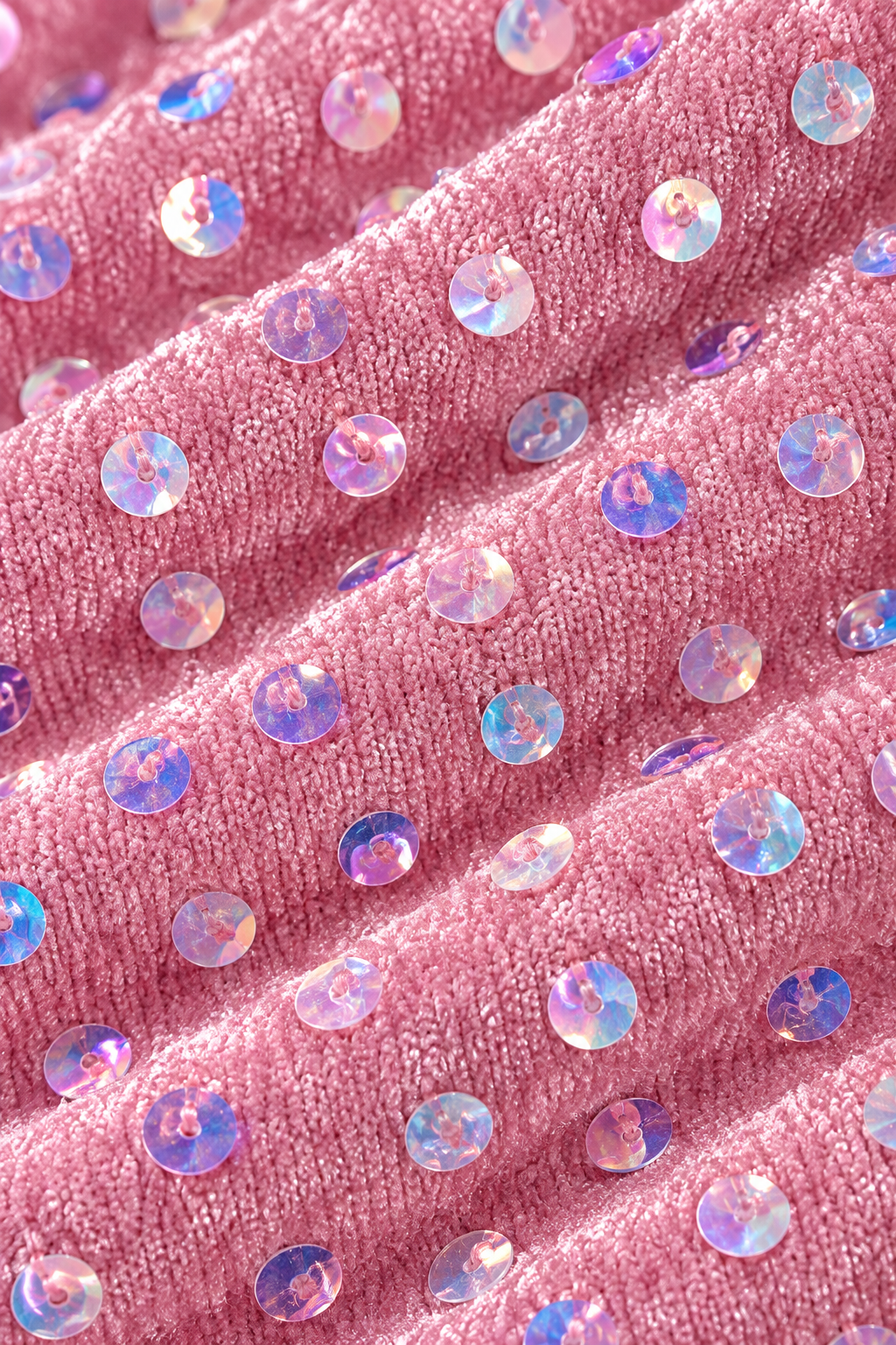 Close-up macro texture detail of rose pink circular sequin embroidery fabric by XALPHEOR
