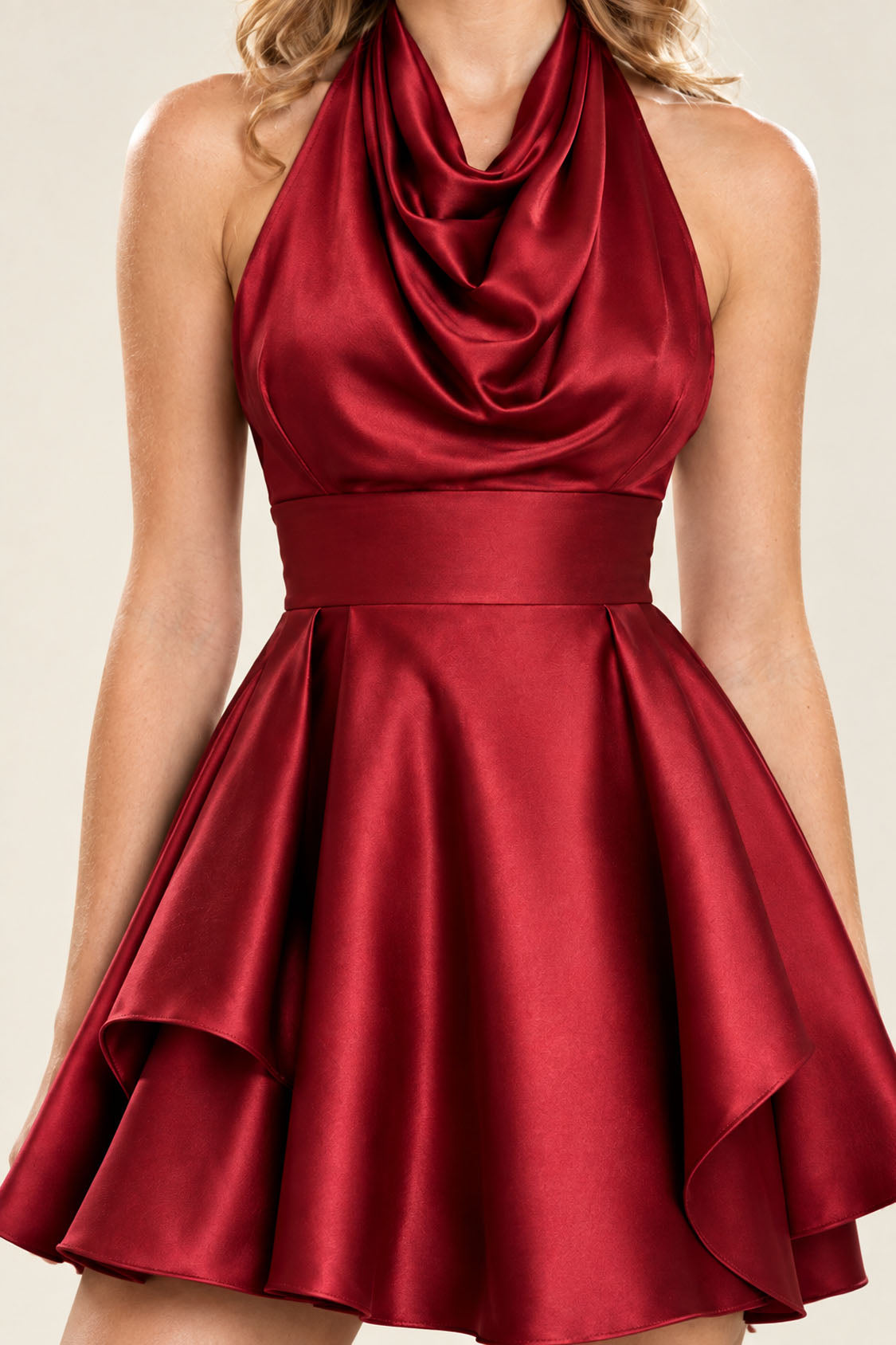 Close-up of red satin cowl neckline, wide waistband and tiered flounce skirt on a homecoming mini dress